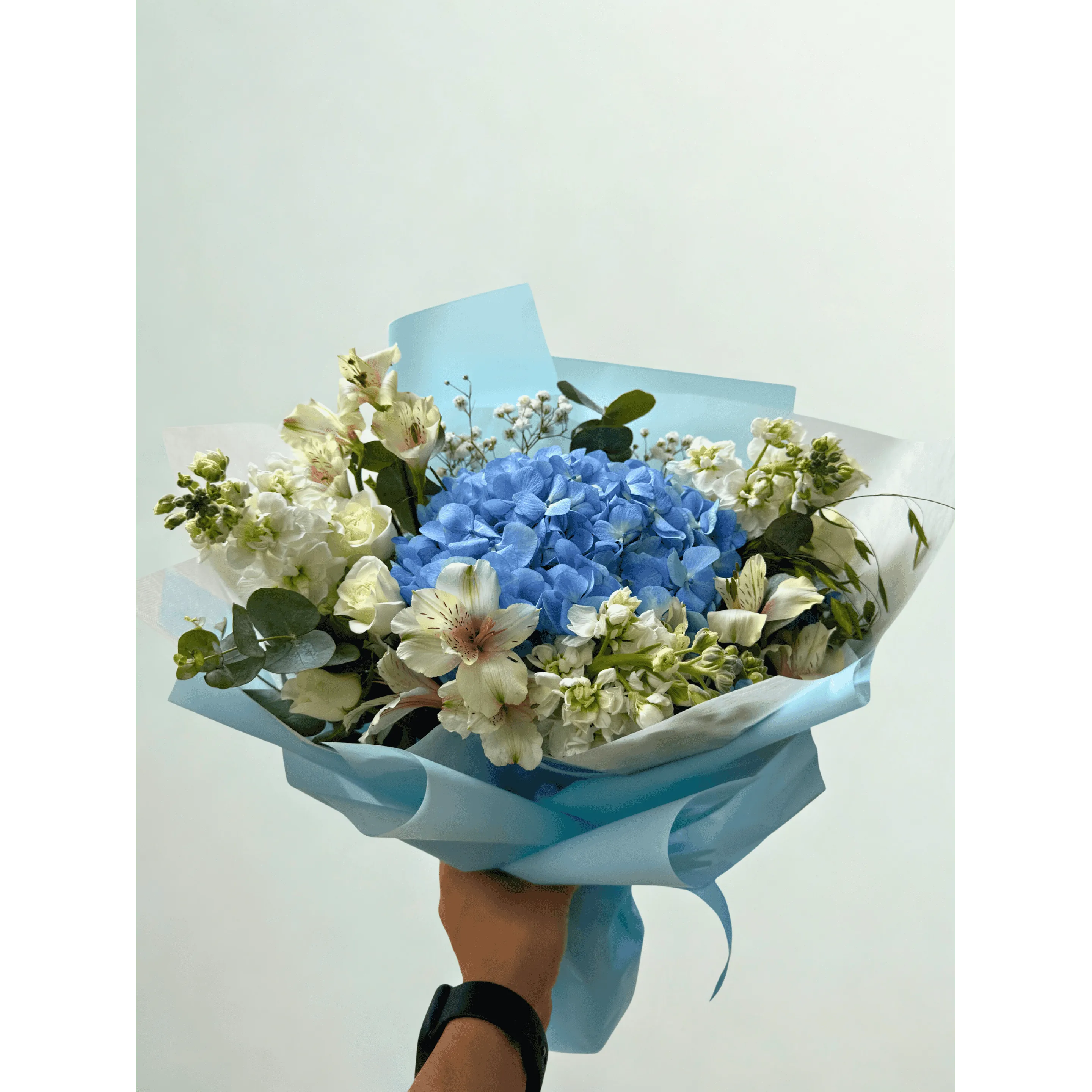 Elegant bouquet with roses, hydrangeas and seasonal blooms in pastel colors